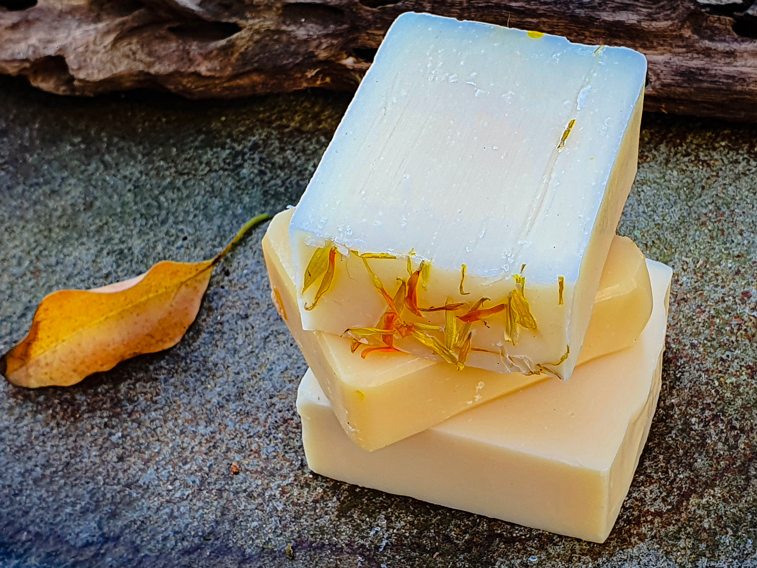 Stack of white and yellow artisan body bar soaps handcrafted by Evee Ivy Oh. For the shower, bath or basin.