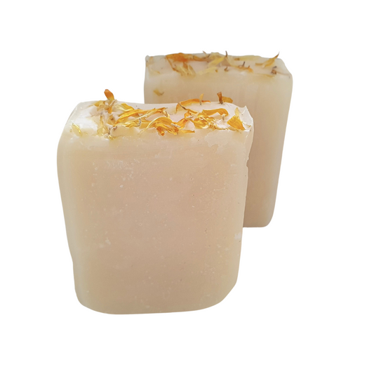 Evee Ivy Oh Orange and Coconut Body bars x 2. Slightly translucent white in colour, Yellow calendula petals sprinkled on top for decoration.