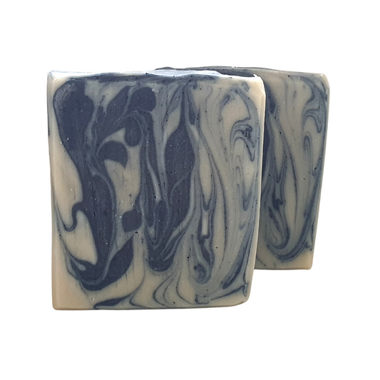 Image of two bars of Evee Ivy Oh's blueberry and shea artisan soap (front view). We use natural indigo to create a blue and white swirling design. Looks and smells good enough to eat.